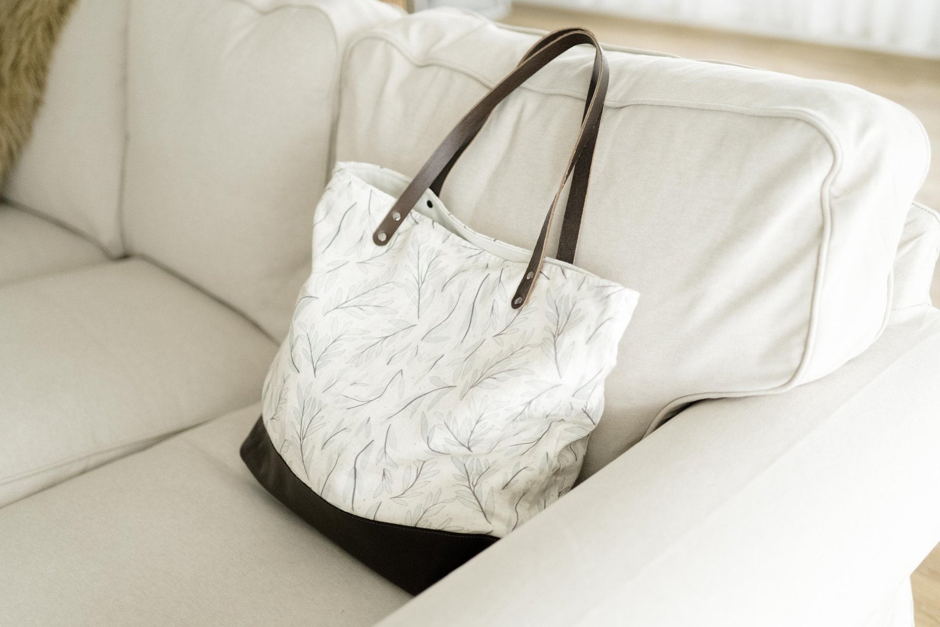 White and gray tote bag with leather straps