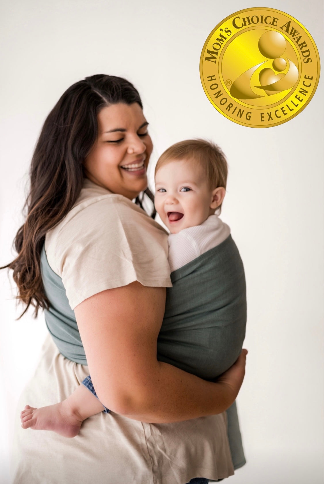 Woman with young infant in ring sling baby carrier and gold award seal