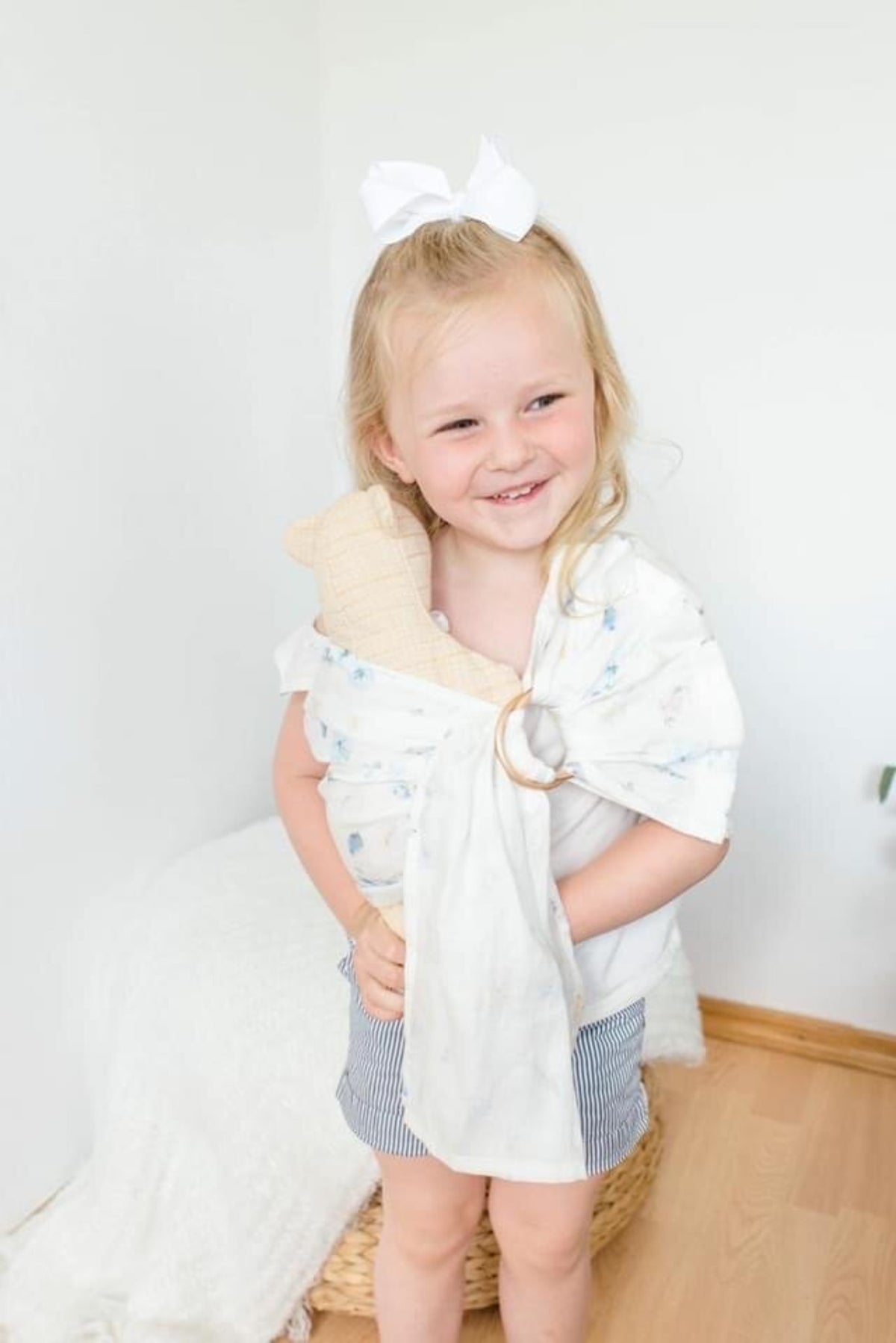 Young girl using white and blue play ring sling